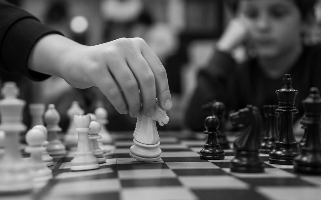 A child moving a chess piece
